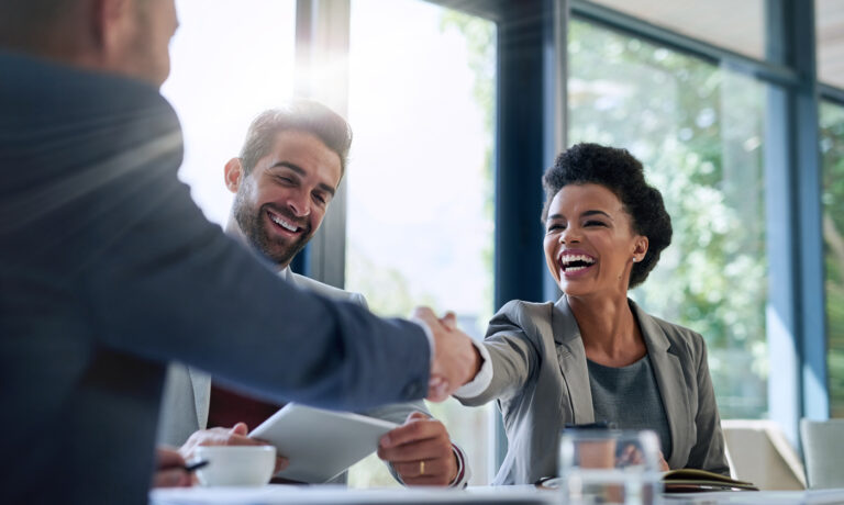 Meeting, partnership and business people shaking hands in the office for a deal, collaboration or onboarding. Diversity, professional and employees with handshake for agreement, welcome or greeting. Outsourced Accounts Payable Transform AP From Chaos to Control 1