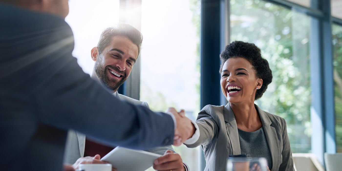 Meeting, partnership and business people shaking hands in the office for a deal, collaboration or onboarding. Diversity, professional and employees with handshake for agreement, welcome or greeting. Outsourced Accounts Payable Transform AP From Chaos to Control 1